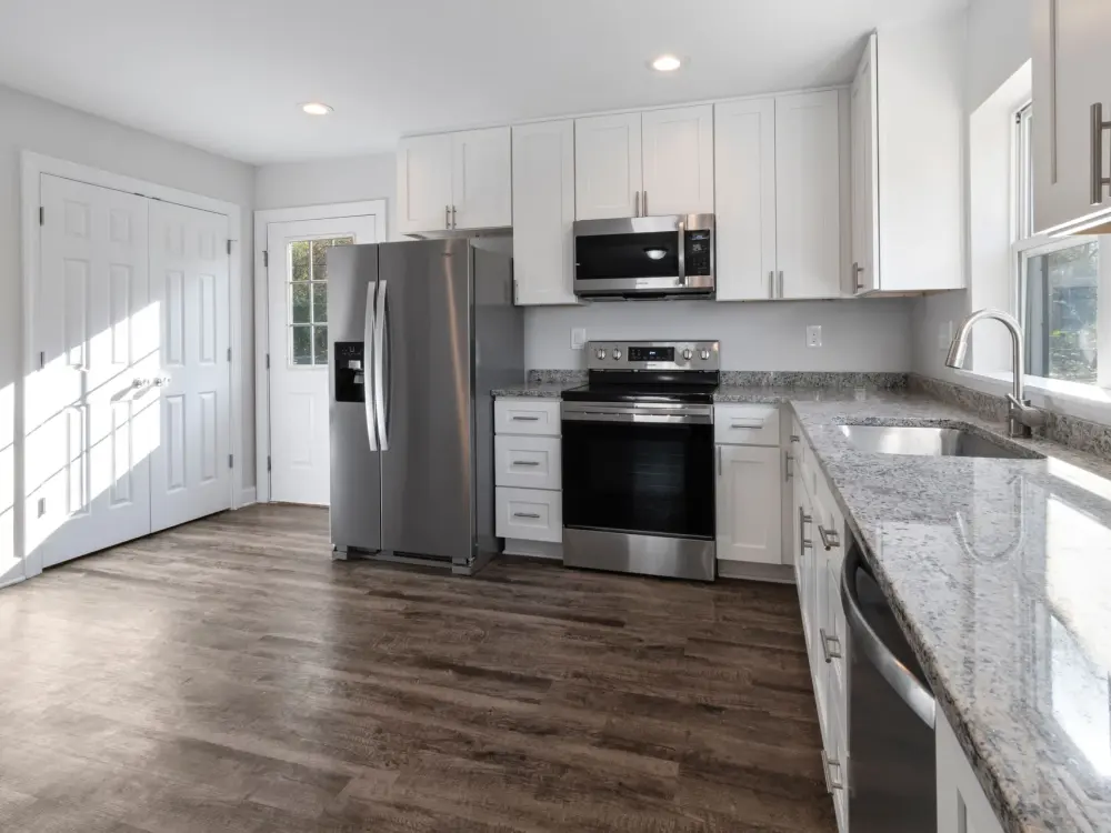 A bright, fully remodeled kitchen with new cabinets and countertops
